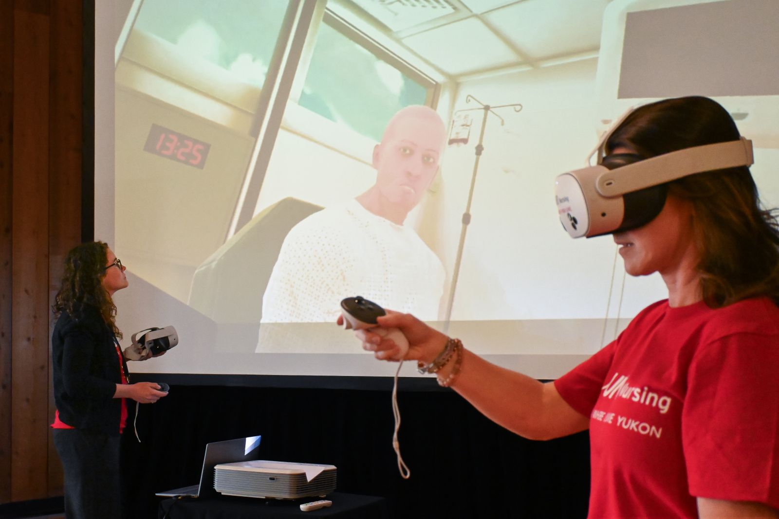 A nurse educator with the University of New Brunswick demonstrates a virtual reality simulator used in training