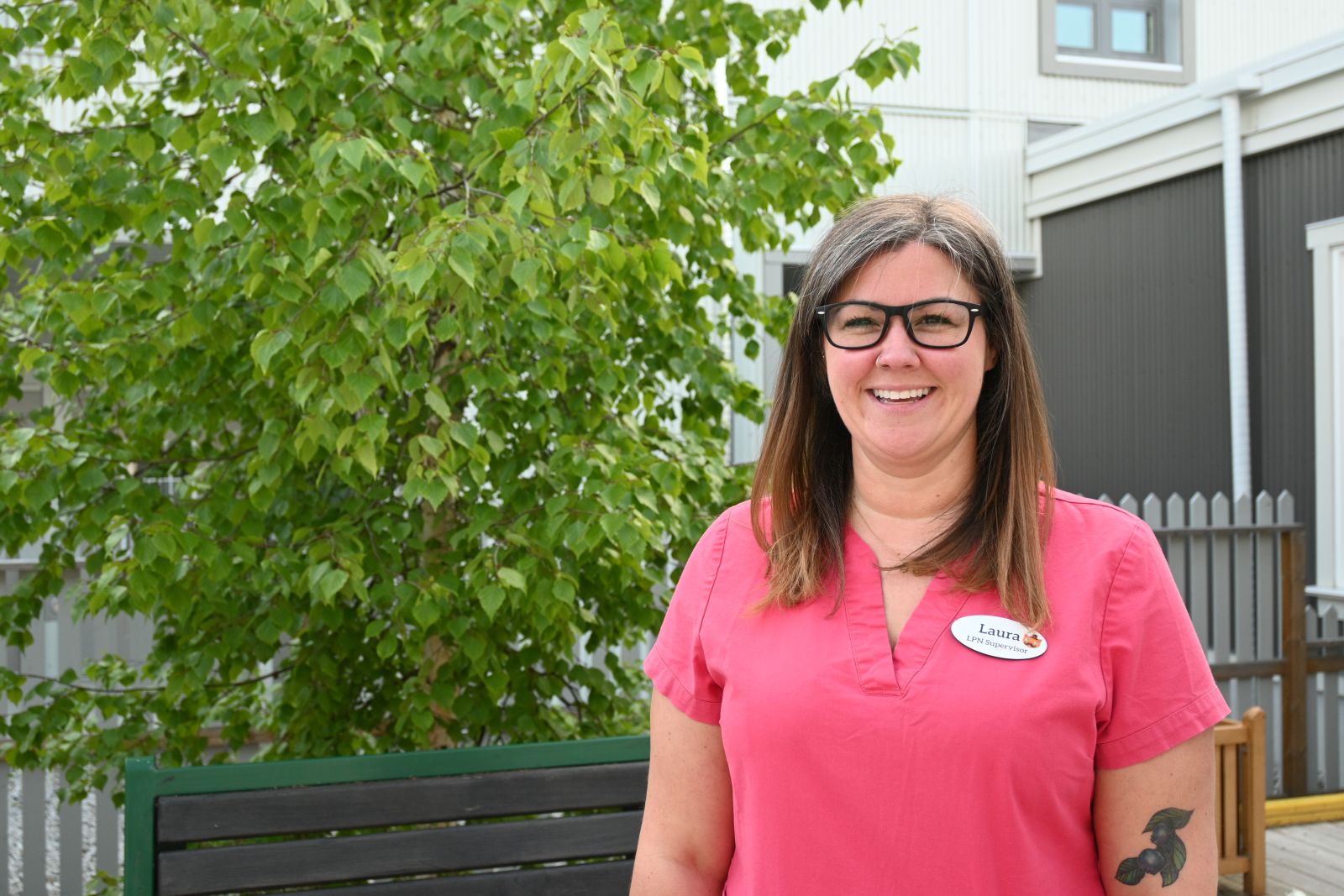 A nurse is shown on the patio of Alexander McDonald Lodge in Dawson City in the sunshine