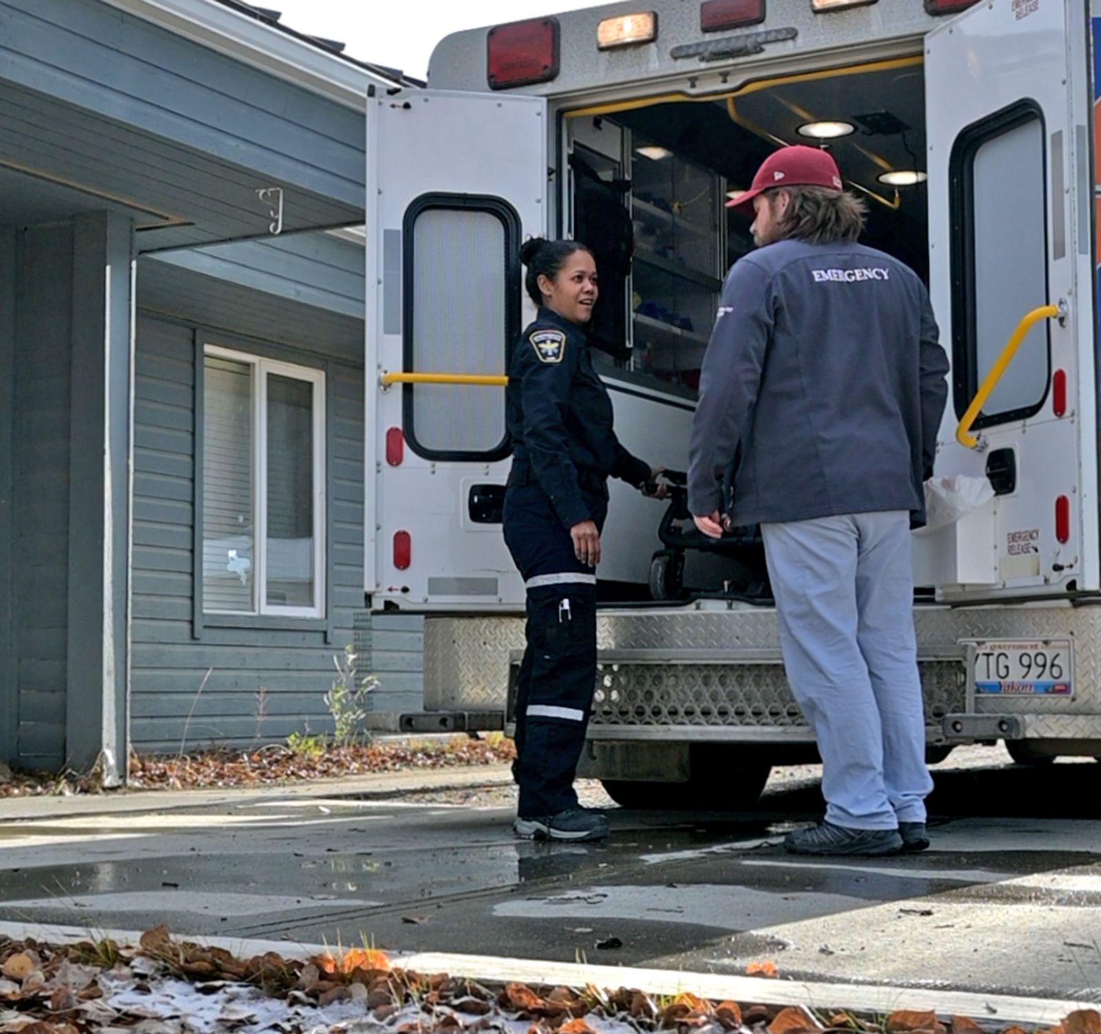 An emergency medical responder speaks with a primary health care nurse in Carmacks