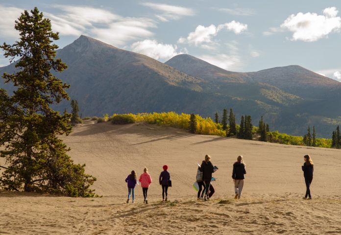 Students and teachers on a field trip in the Carcross desert.