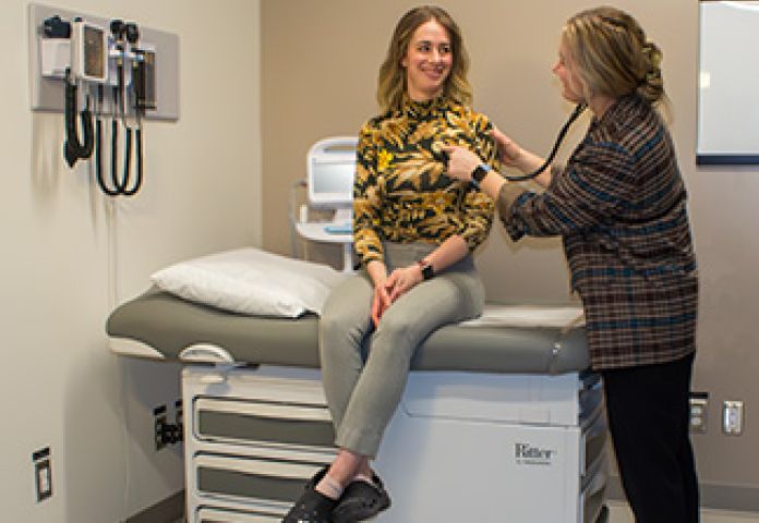 a nurse listening with a statoscope. 