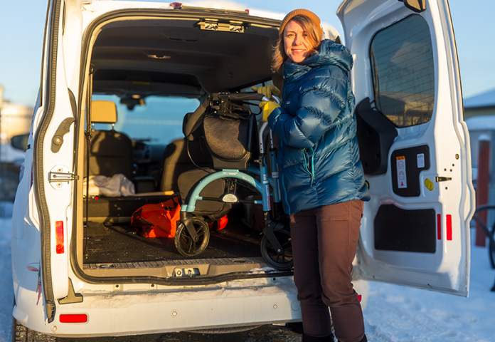 a person standing by a van with equipment. 