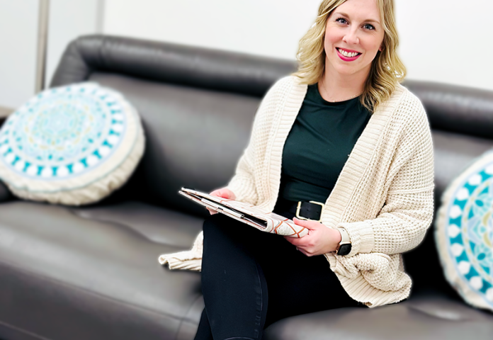 a person sitting on a sofa in an office. 