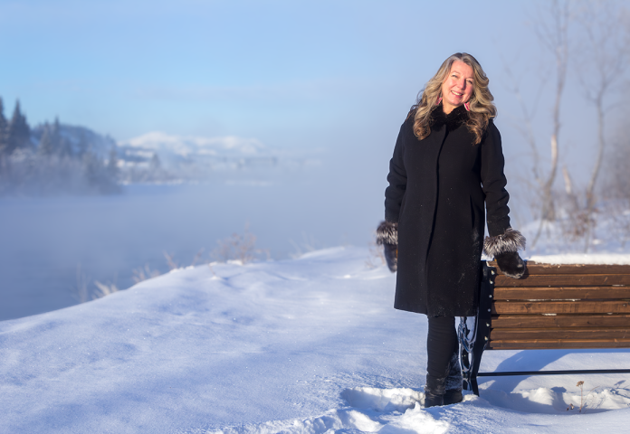 a person standing outside by a bench.