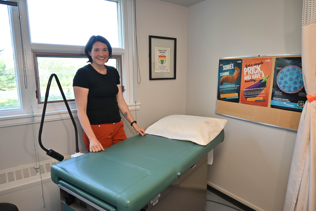 person standing by a patient bed