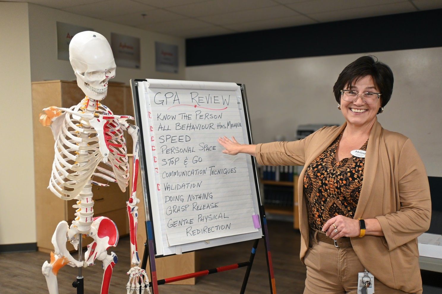 nurse pointing at a flip board