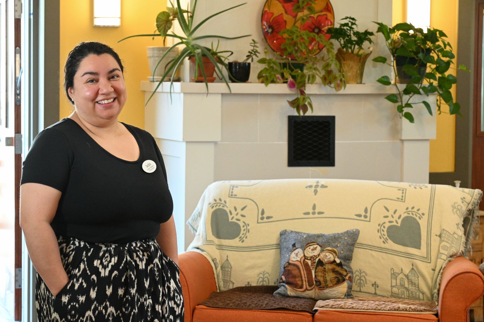 nurse standing by a fireplace and a seating