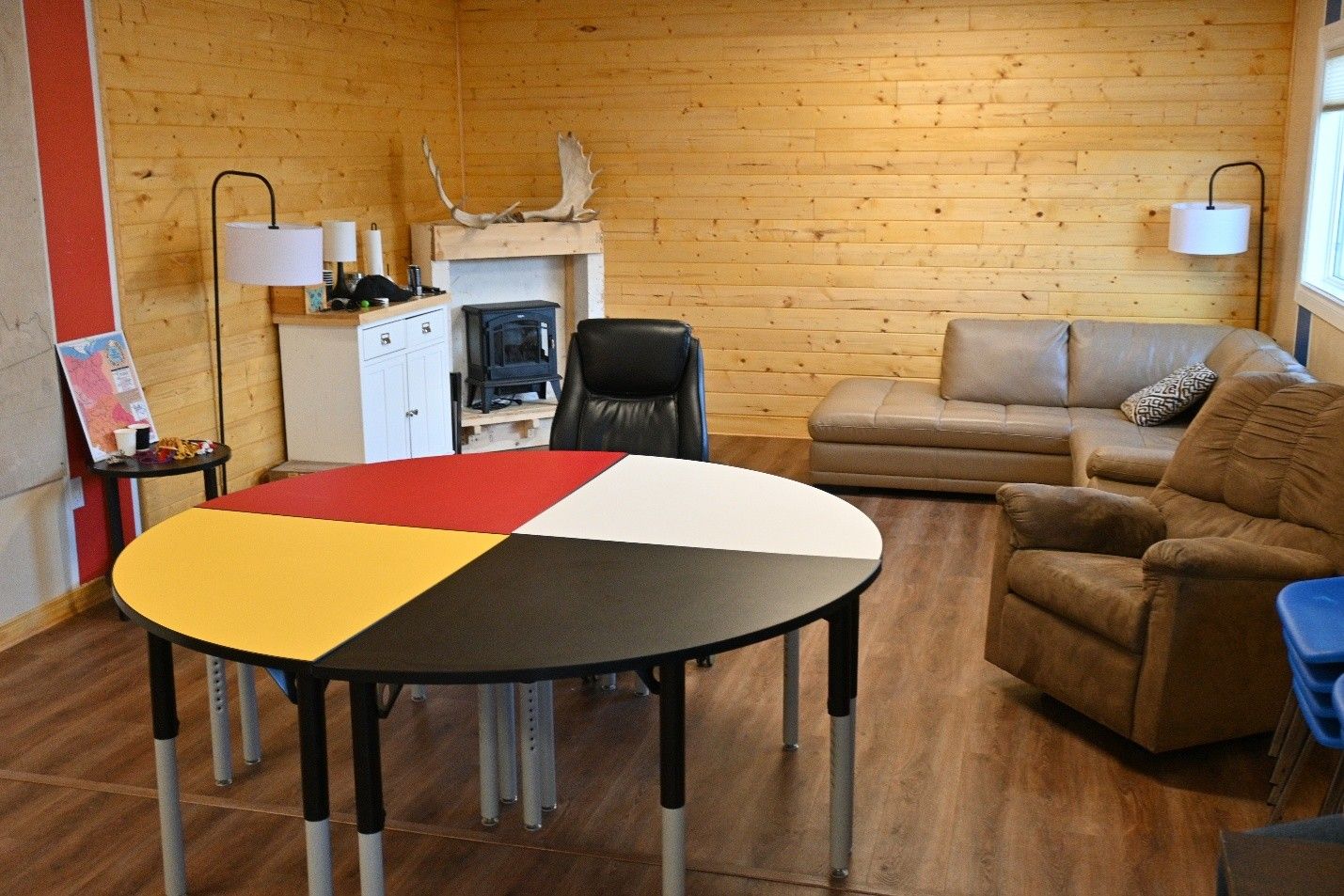 a room with table, seats, microwave and furnishing
