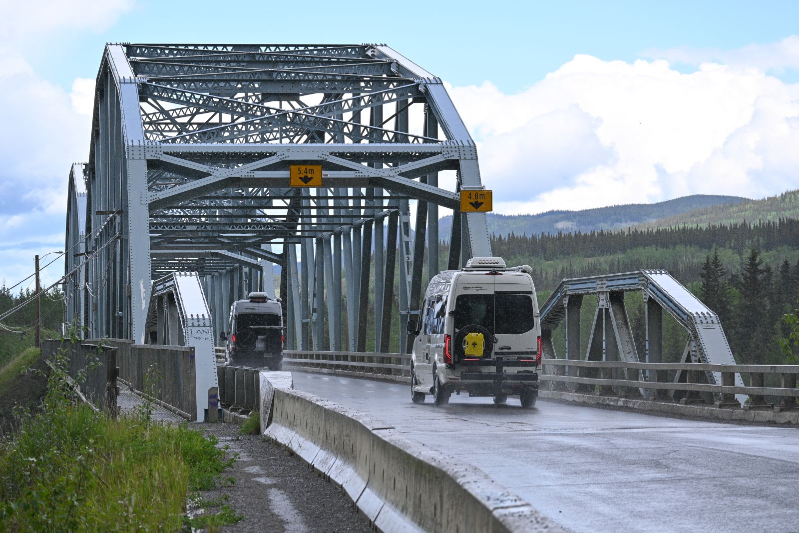 Tourists take the scenic bridge travelling towards Dawson City