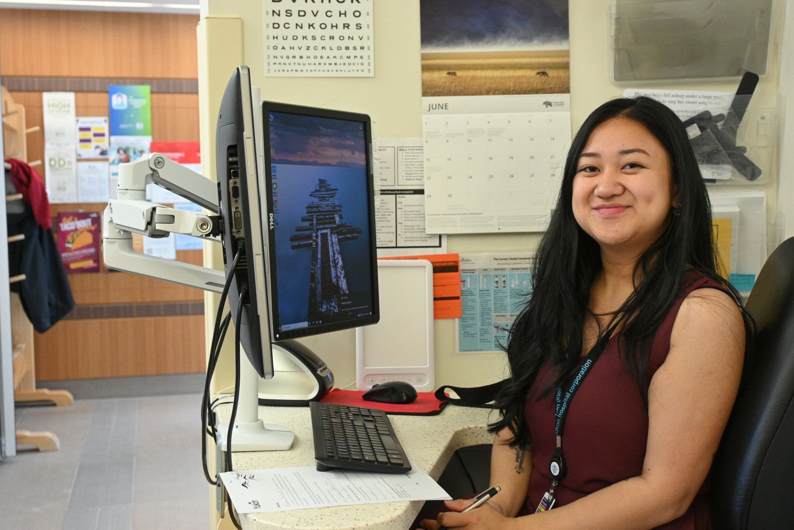 A medical office assistant is shown at work in Dawson City