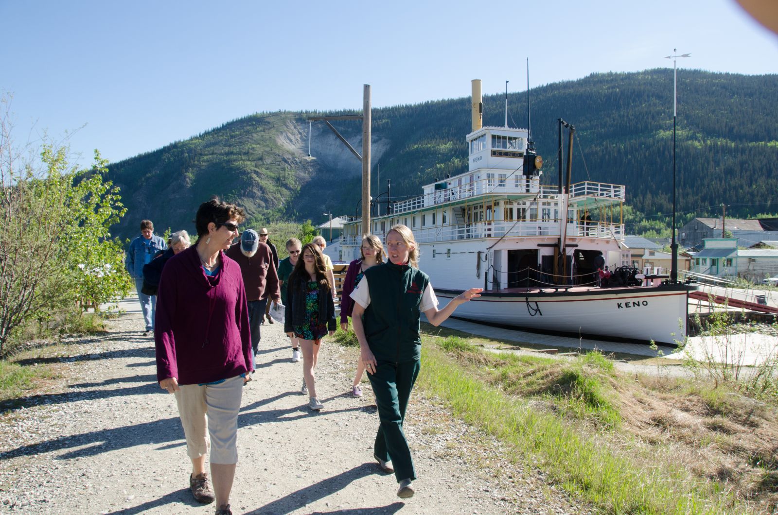 A walking tour takes a crowd past the S.S. Keno National Historic Site.