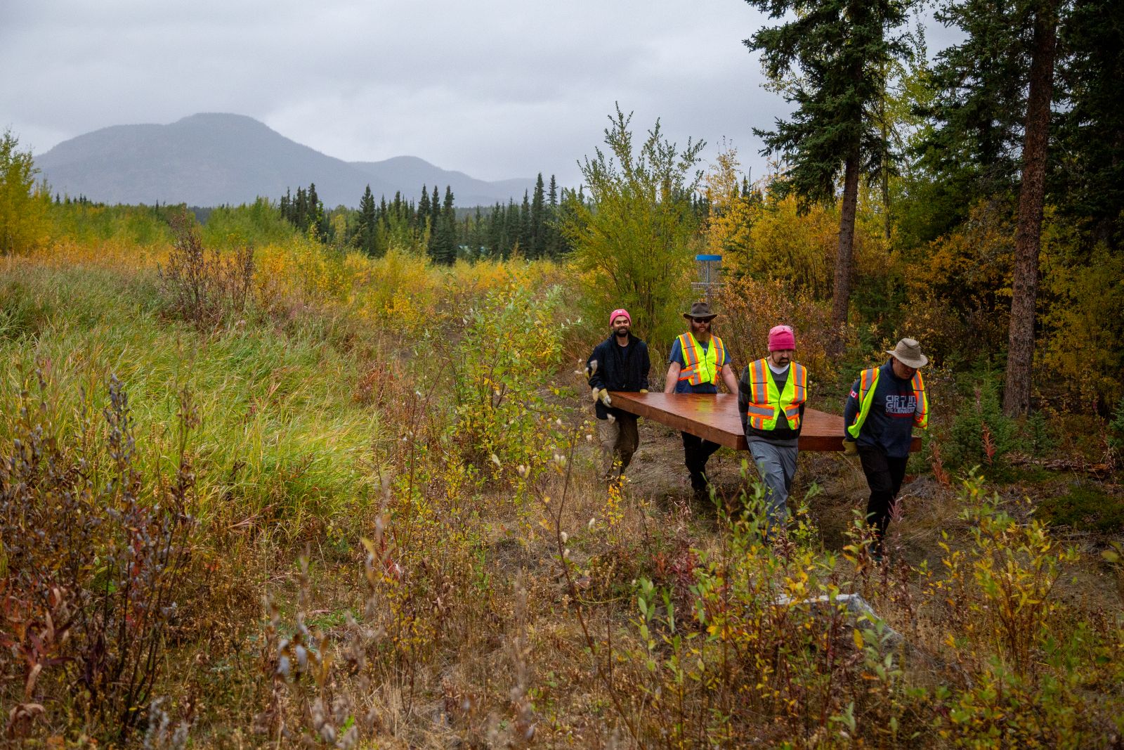 Volunteers put in an effort to help build the Teslin Disc Golf course.