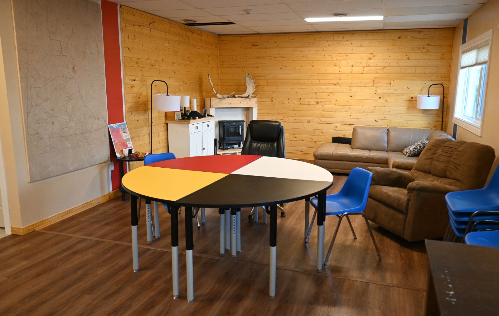 A table in the cultural space at  Nts’äw Chua has colours of the medicine wheel