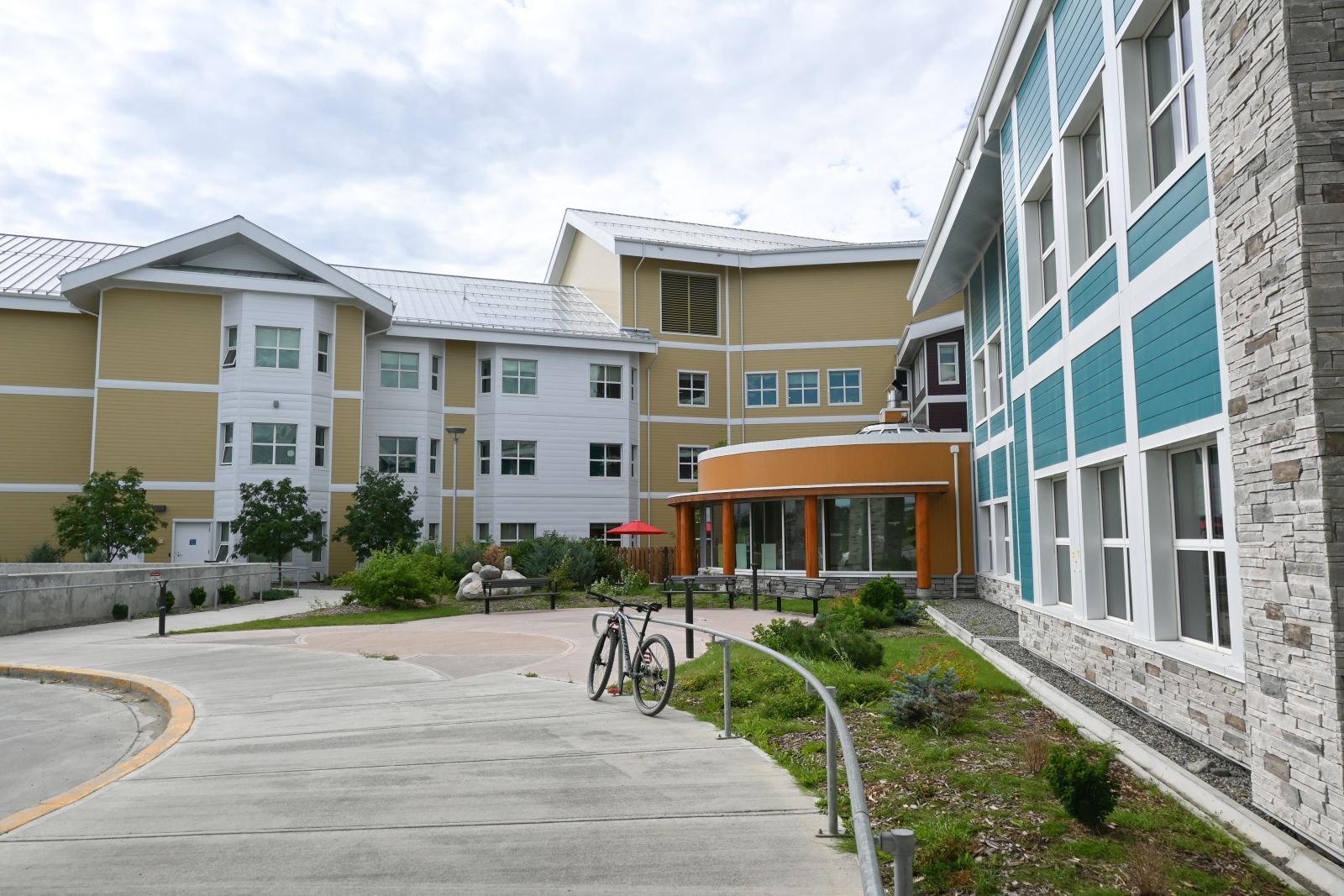 An exterior view of Whistle Bend Place in the summer in Whitehorse