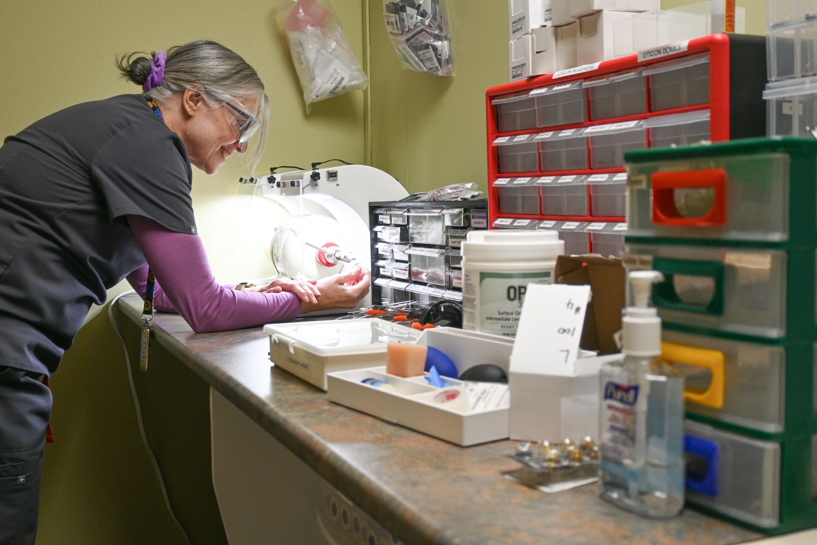 A audiologist is shown in the repair shop at Hearing Services in Whitehorse