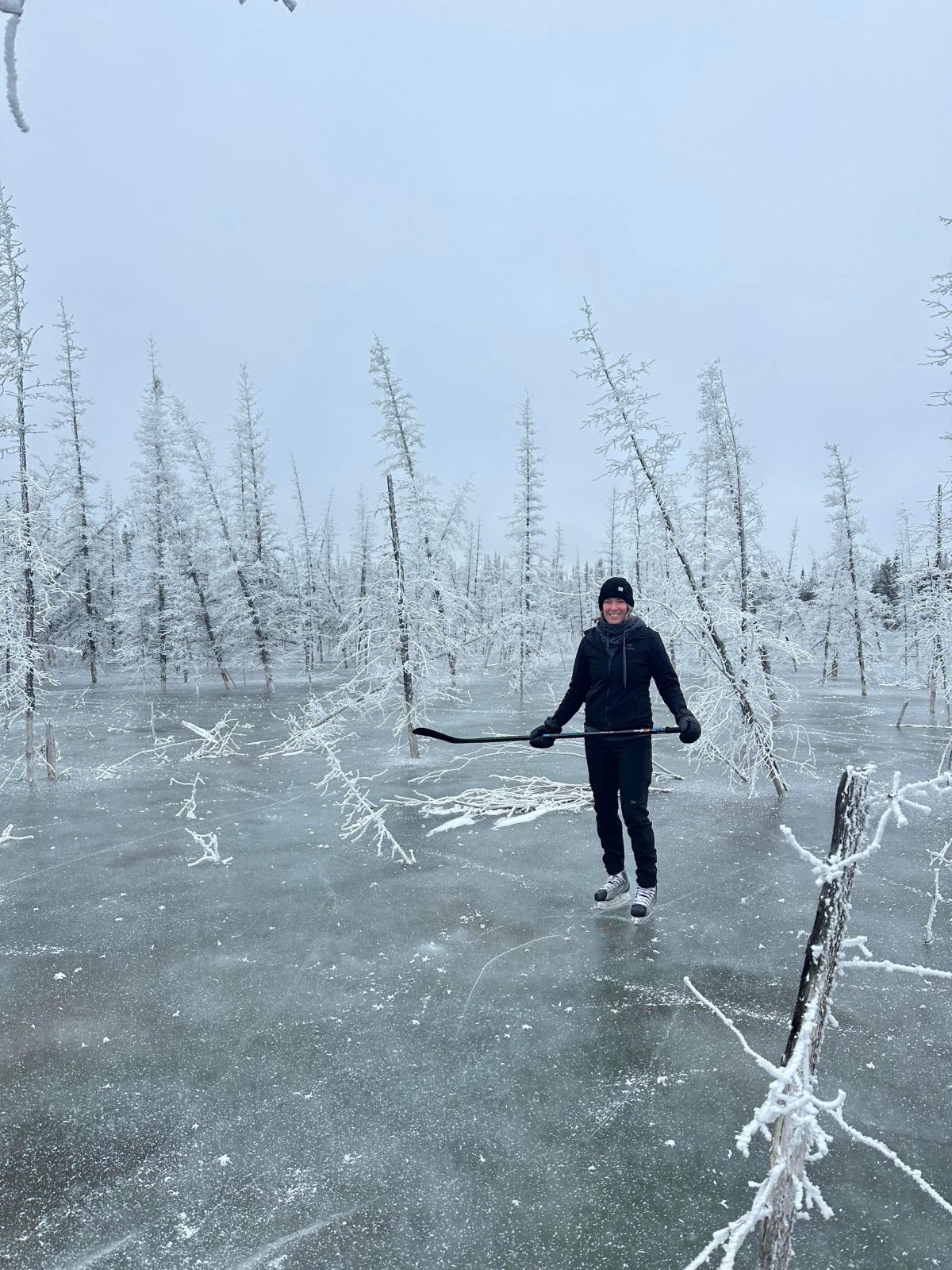 A person is pictured playing hockey in a field in the Yukon
