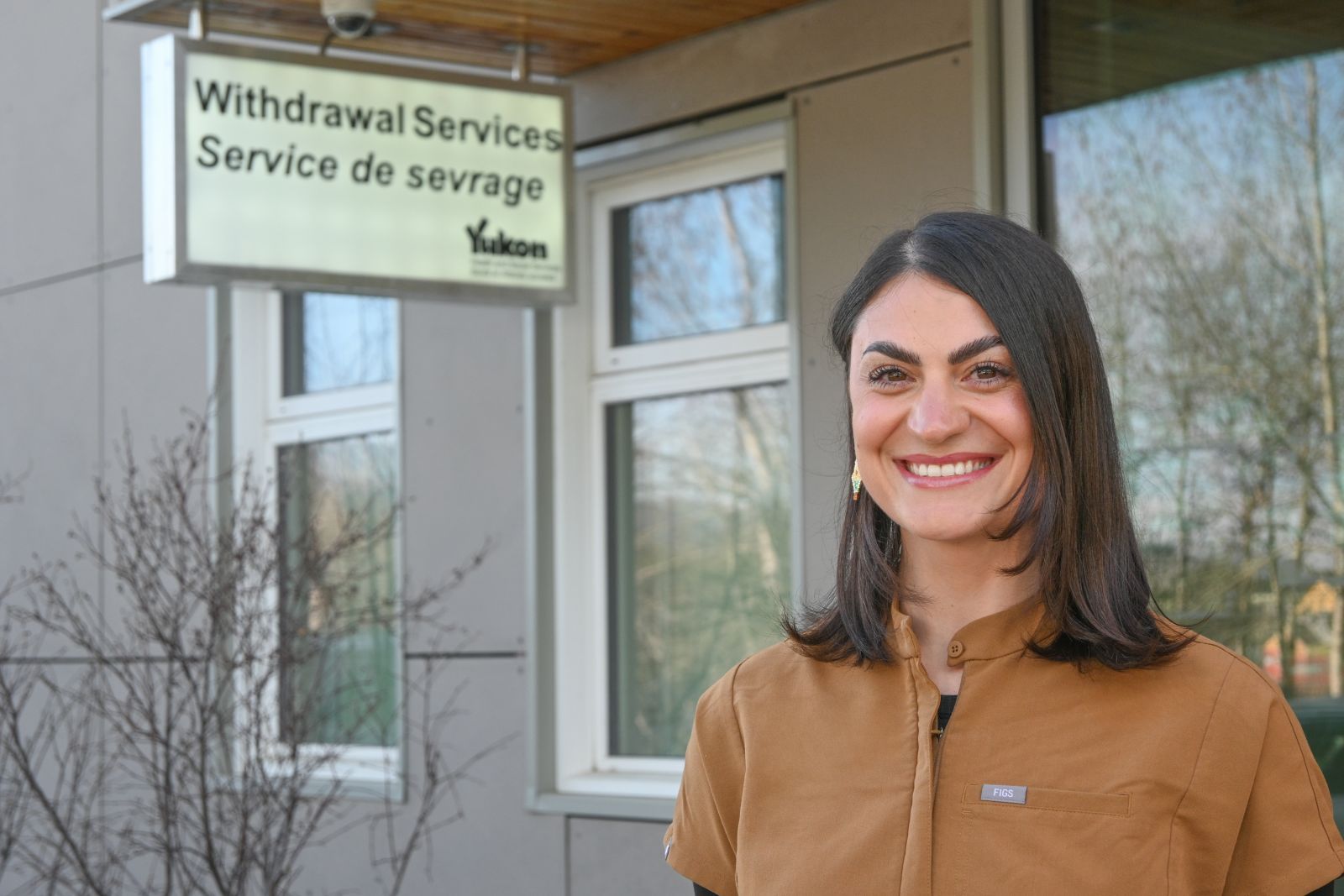 A Licensed Practical Nurse in the Yukon is outside the Sarah Steele Building