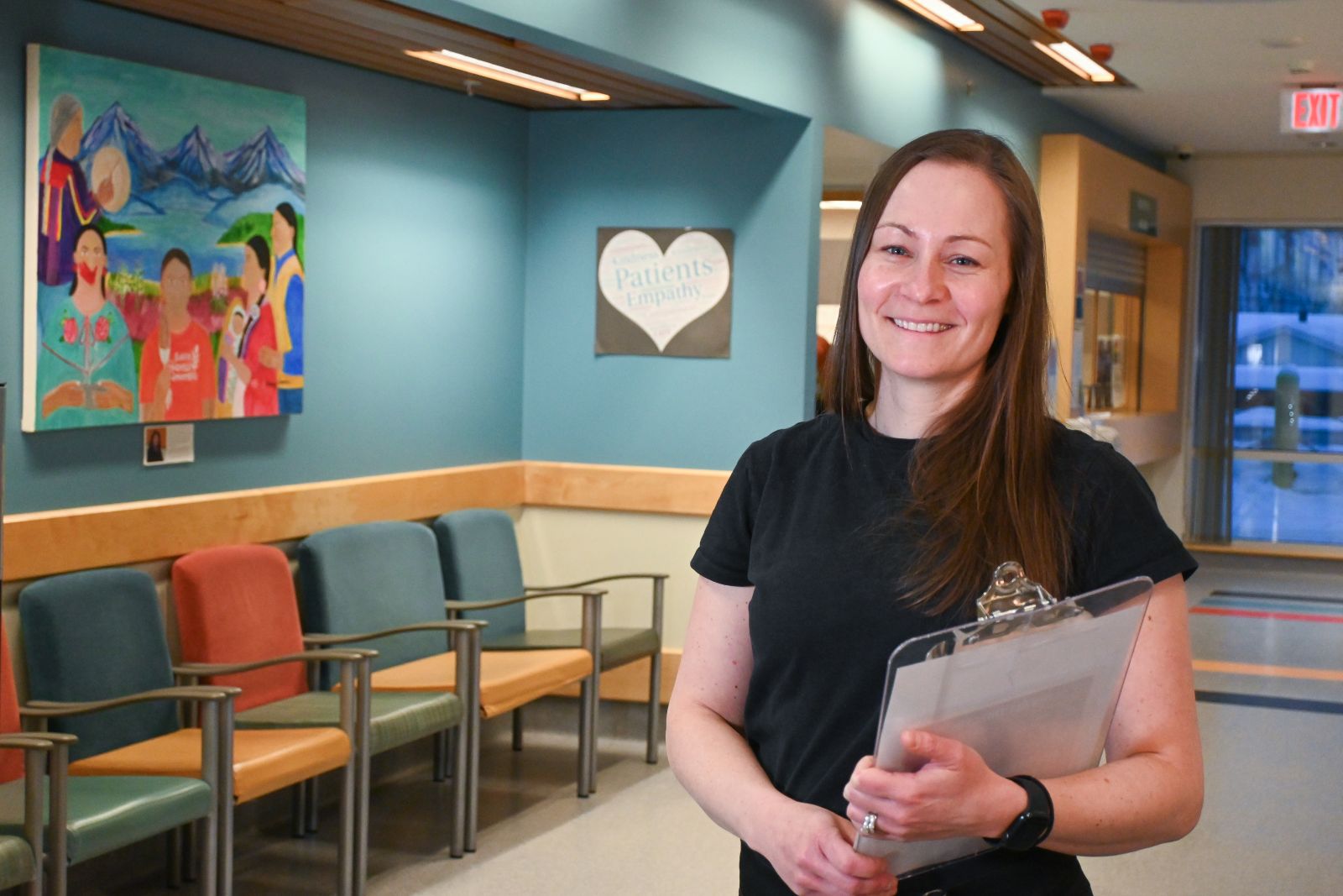nurse in hospital facility holding clip board