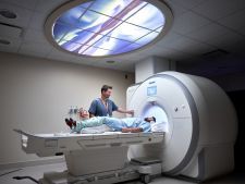 patient laying prone going into scanning machine