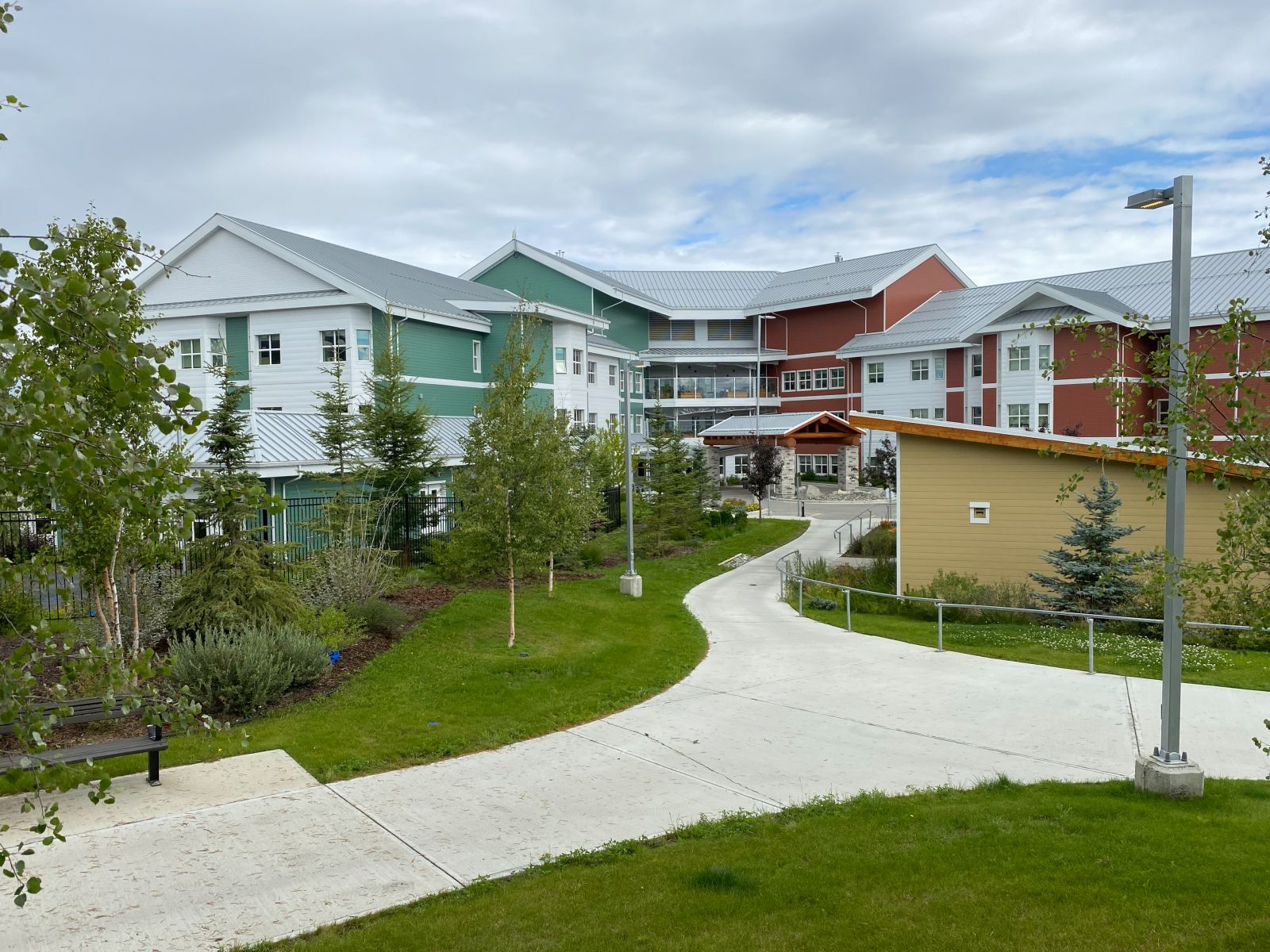 Walking paths at Whistle Bend Place include a garden with labelled plants