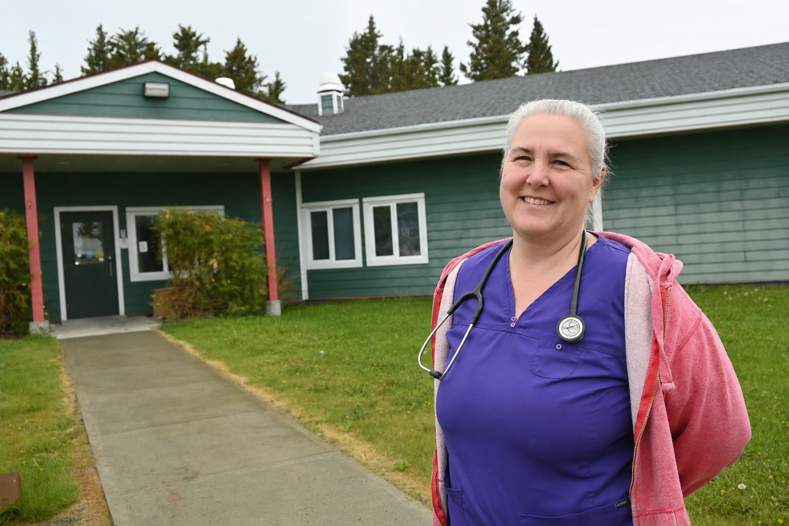 A nurse is shown in Teslin, Yukon outside her place of work.