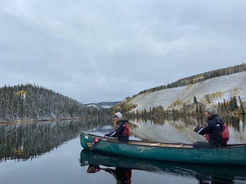 Park officers on canoe.