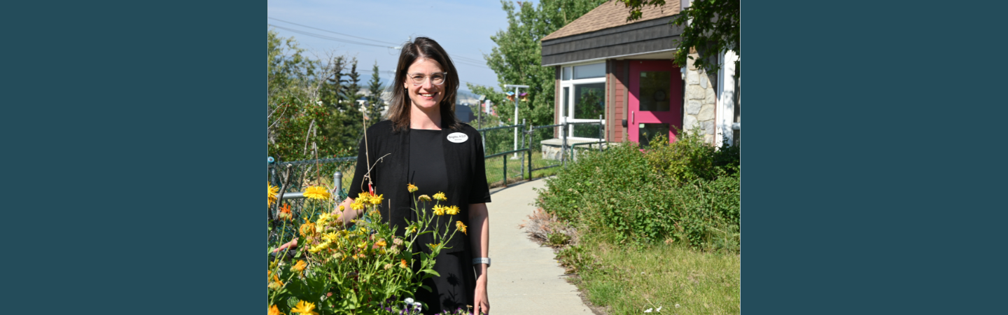 The exterior of Thomson Centre in Whitehorse features a well-maintained flower garden in the summer