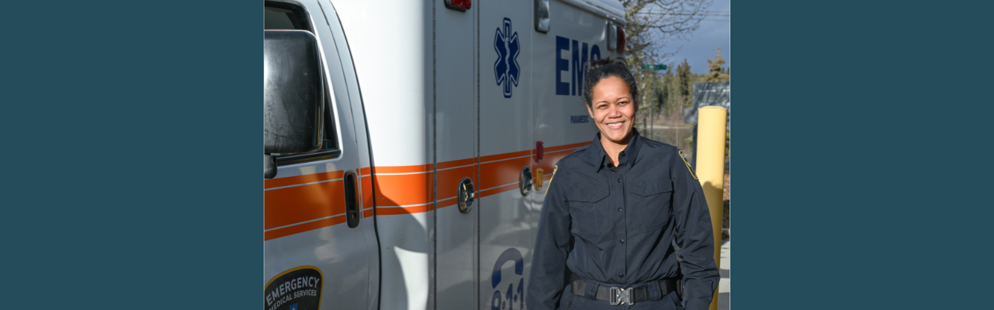 An emergency medical responder is shown alongside an ambulance in Carmacks, Yukon