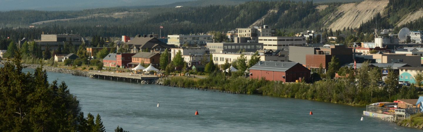 A scenic view of Whitehorse alongside the Yukon River.