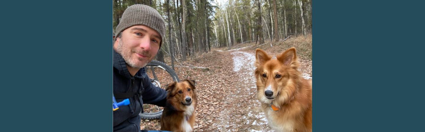 a social worker is show on a path with his dogs in the Yukon