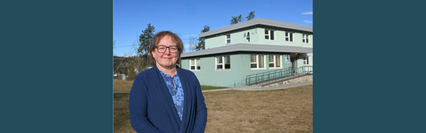A manager of Yukon Communicable Disease Control stands before their offices in Whitehorse