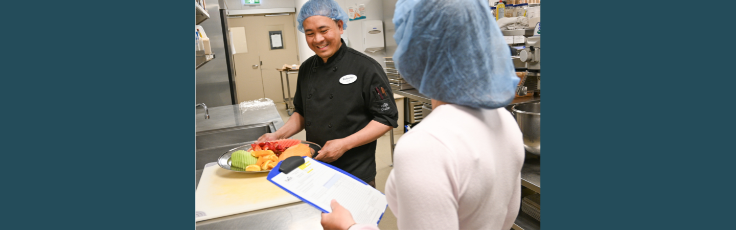 Cooks are seen in the kitchen at Whistle Bend Place